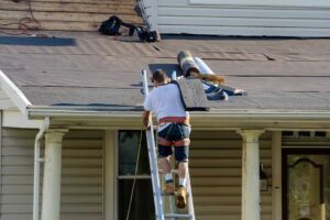 Homeowner inspecting a roof for mold and mildew growth after rain, with visible discolored shingle patches.